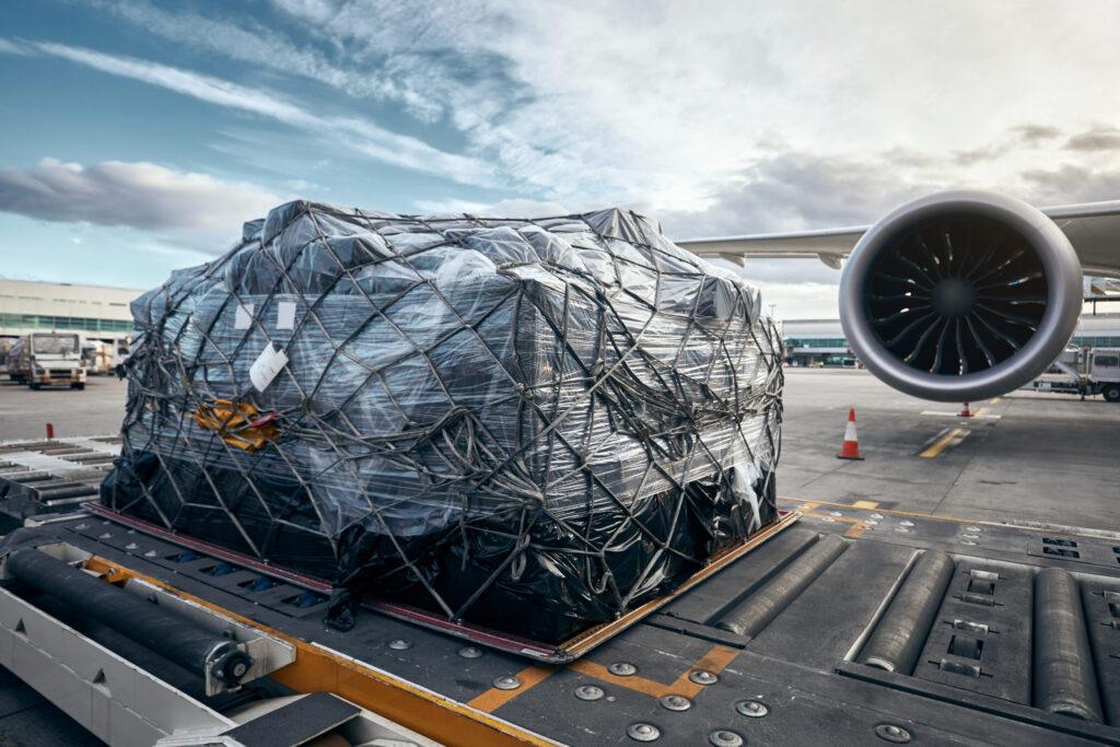 Packaged cargo being loaded on airplane